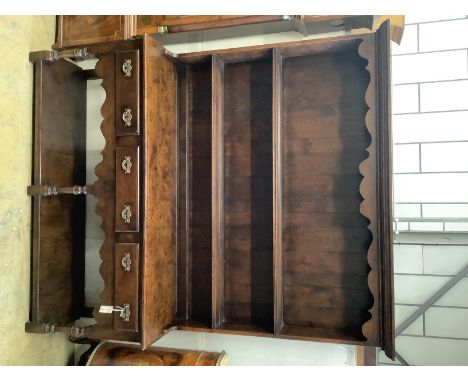   An 18th century style oak dresserhaving two-tier boarded plate rack over three drawers and pot shelf, on turned supports, w