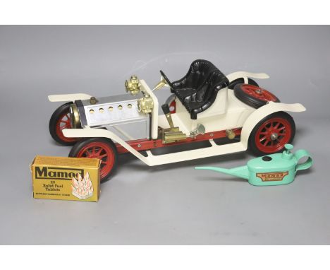   A Mamod live steam vintage two-seater roadster, with silver and cream paintwork and red wheels, oil can