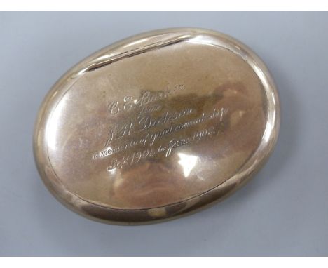   An Edwardian silver oval tobacco box, with engraved inscription, Chester, 1905, 9.7mm, 94 grams.