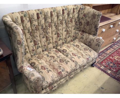   A barrel back upholstered 1920's two seat sofa, length 140cm, depth 70cm, height 110cm