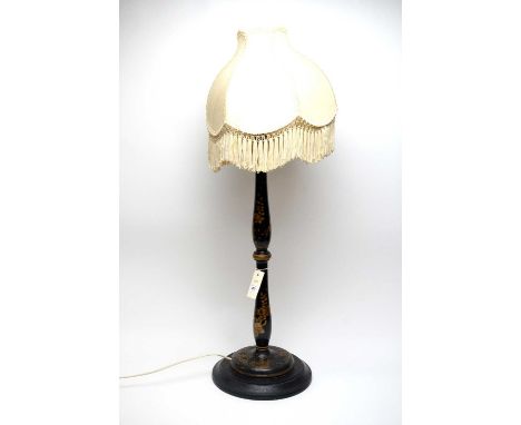 A Chinoiserie black lacquered table lamp, the knopped baluster stem terminating in a circular foot, with gilt floral and temp