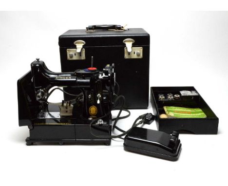 A Singer 222K electric sewing machine, with manual, in carry case.