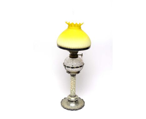 A German ‘The Wizard’ oil lamp, with cut glass reservoir and ombre lemon yellow glass shade, clear glass funnel, raised on a 