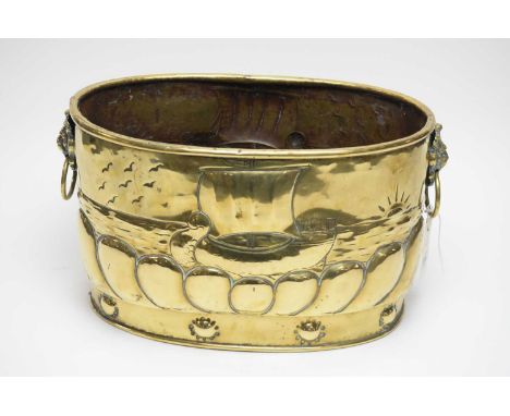 A Dutch patinated brass coal scuttle or planter, the body with panoramic sailing scene, twin lions head and ring pull handles