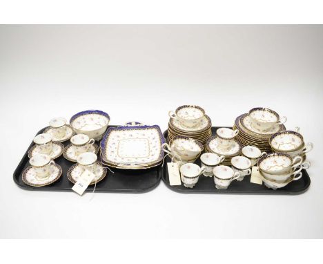 A Cauldon England rose decorated tea and coffee service, decorated with fields of roses within cobalt and gilt borders, compr