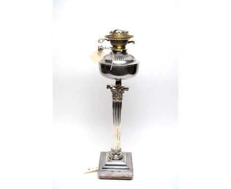 A Victorian silver plated Messengers Patent oil lamp, with plated reservoir, over a Corinthian column support and stepped squ