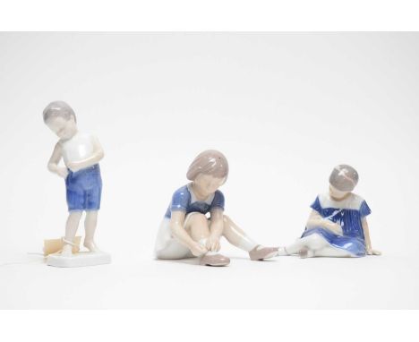Three Danish ceramic figures of children, by B&amp;G Denmark, including: a figure of a boy, modelled standing, 15cms high; an