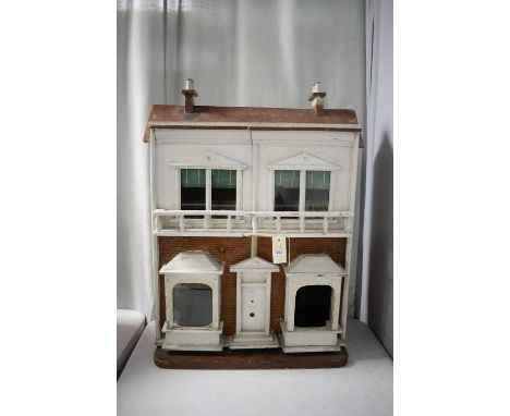 A vintage two storey dolls house, in the form of a town house, with faux brick and white painted façade, the twin hinged fron
