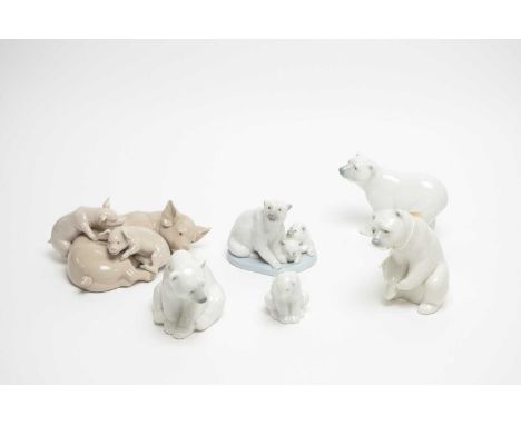 A collection of four Lladro ceramic polar bear figures, the tallest 12cms high; together with a Nao polar bear figure; and a 