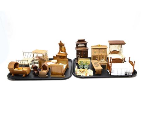 A collection of vintage dolls house bedroom furniture, including: three wooden rocking cradles; a brass framed bed; a white p