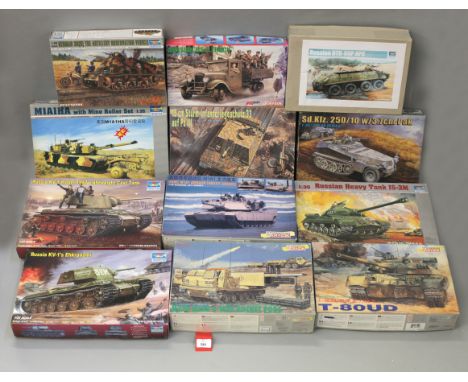 Twelve boxed military related model kits by Dragon and Trumpeter, including tanks and military vehicles in 1:35 scale. One of
