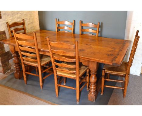 A Large Oak Refectory Style Dining Table, the plank top above a plain frieze raised upon four turned legs with central stretc