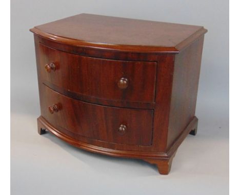 Apprentice mahogany bow front chest of drawers, the moulded top over two long drawers on bracket feet, the drawer interiors w