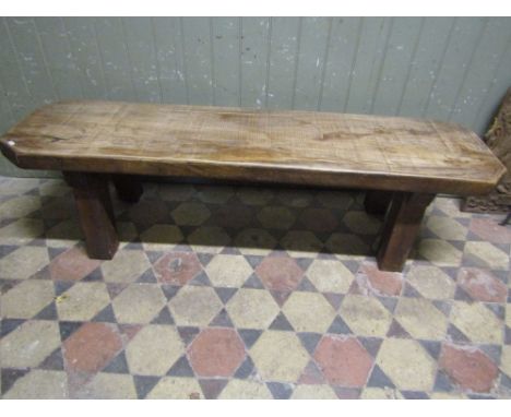 A rustic oak pig type bench with canted corners and square cut supports, 5ft long approx