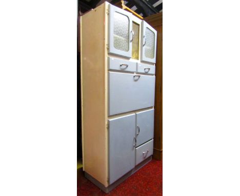 A mid-20th century floor standing kitchen cabinet, with light blue and cream painted finish, enclosed by an arrangement of cu