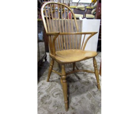 A good quality traditional Windsor hoop and stick back armchair in ash with saddle shaped seat raised on turned  supports uni