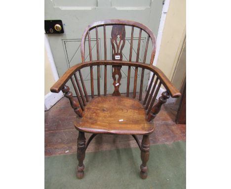 A 19th century Windsor comb back elbow chair with shaped and pierced splat, raised on turned supports with Crinoline stretche