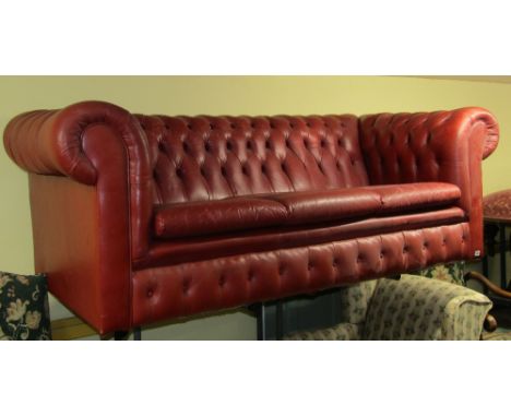 Victorian style three seat Chesterfield sofa upholstered in maroon leather, with deep button back to seat three, 220cm wide