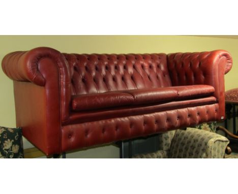 Victorian style three seat Chesterfield sofa upholstered in maroon leather, with deep button back to seat three, 220cm wide