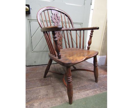 A Georgian Windsor comb back elbow chair, principally in Yew wood, with ash seat, on turned supports with crinoline stretcher