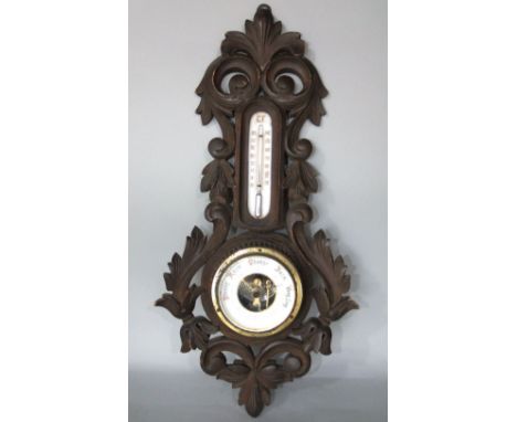 Attractive barometer/thermometer with carved scrolled leaf frame and open working, with mercury thermometer, 45 cm high