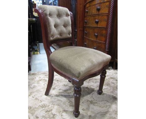 A set of six Victorian mahogany dining chairs with beige ground upholstered seats and scrolled padded backs, raised on turned