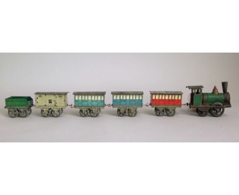 Early tin plate railway engine, 1" gauge, the clockwork engine pulling a tender, three passenger carriages and a goods wagon 