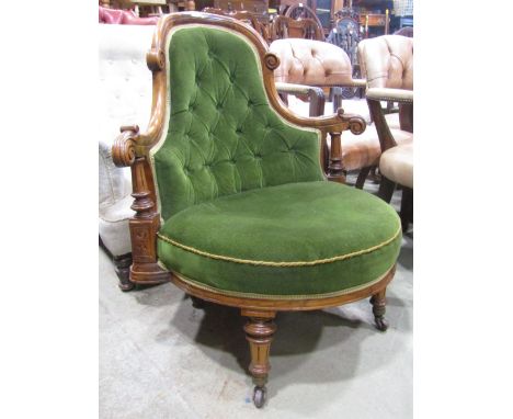 An unusual Victorian walnut drawing chair with green dralon upholstered bow fronted seat and button back within a carved and 