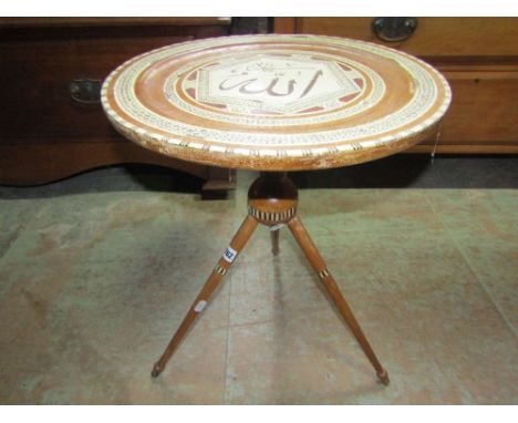 An Islamic occasional table of circular form with geometric bone inlay detail and raised on tripod supports