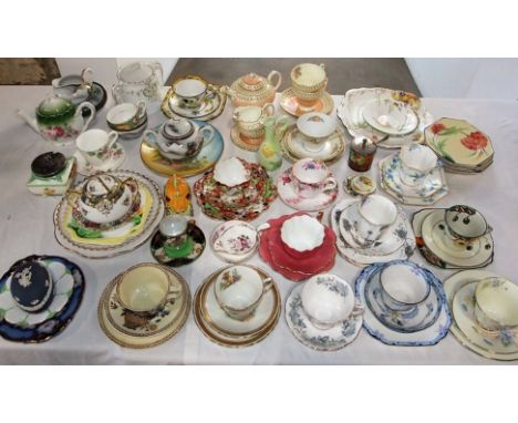 A quantity of decorative tea ware trios comprising Royal Doulton, Melba china, Royal Albert, Clarice Cliff and other examples