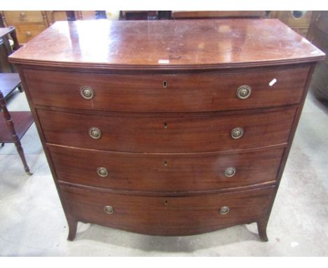 A Regency mahogany bow fronted bedroom chest of four long graduated oak lined drawers with ebony detail over a shaped apron a