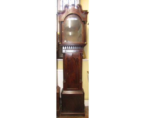 A Regency mahogany longcase clock case with string banded detail, the trunk with reeded column supports, the door with Gothic