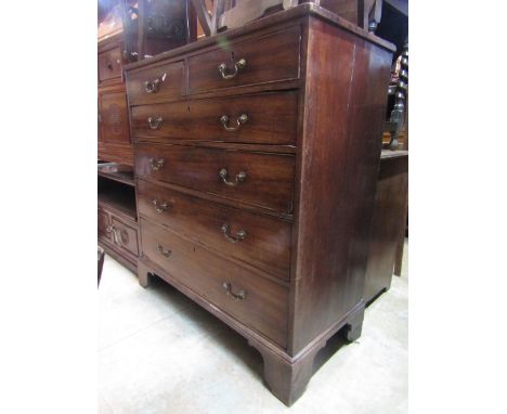A Georgian mahogany bedroom chest of four long and two short graduated drawers with brass swan neck handles and bracket suppo