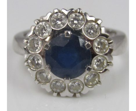 A sapphire and diamond cluster ring in 18ct white gold, size L/M, 6.6g