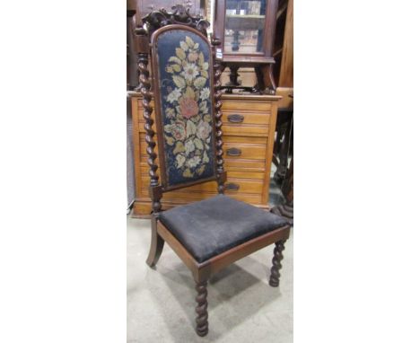 A Victorian rosewood nursing/prayer chair, the tall raised back incorporating an arched floral tapestry panel flanked by spir