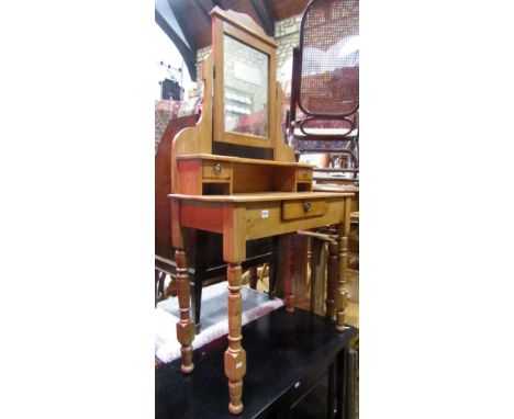 An Edwardian stripped pine dressing table with central swing mirror, together with an Edwardian oak two door hanging wall cup