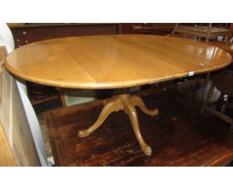 A good quality light oak draw leaf D end dining table with single additional leaf and moulded outline raised on a central tur