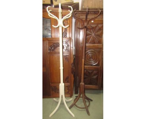 Two floorstanding hat/coat stands (slight variant in design), one with painted finish
