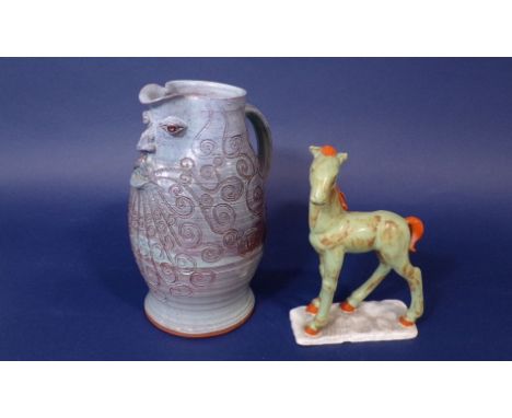 An unusual continental ceramic model of a pony with green and orange glazed finish, stamped "Foreign" to base, 24cm tall, tog