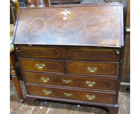 An 18th century walnut bureau, two long and two short drawers, the fall flap enclosing the original stepped interior, with we