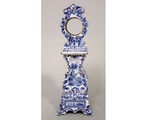 A late 19th century tin glazed earthen ware Delft type watch case in the form of a longcase clock, with blue and white painte