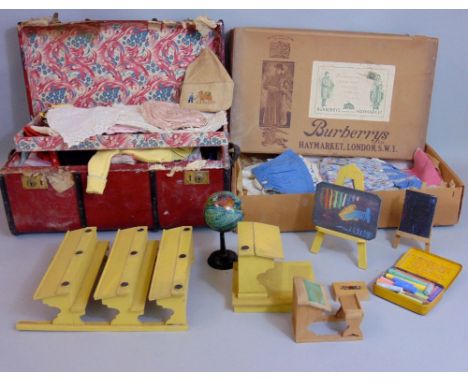 A Victorian child's Pormanto trunk containing a collection of hand worked and other vintage dolls clothing and a further card