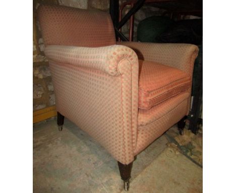 An Edwardian drawing room chair with rolled arms, square lattice patterned terracotta ground upholstery and loose feather fil