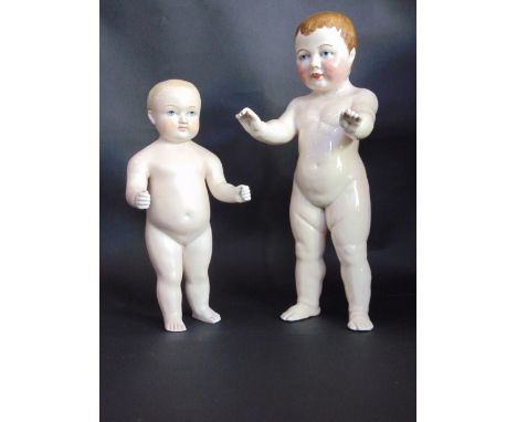 Two glazed ceramic character dolls with painted features, 37 cm and 28 cm in height