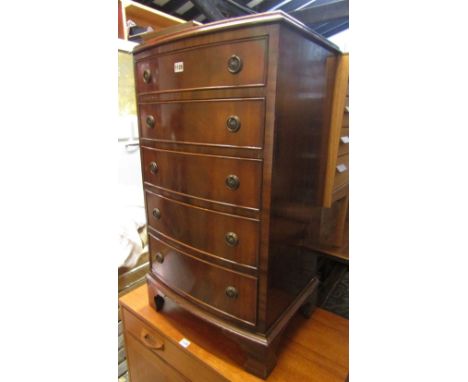 A small reproduction Georgian style mahogany veneered, bow fronted chest of five long graduated doors, raised on bracket supp