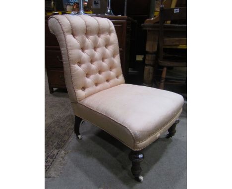 A Victorian nursing chair with light pink velvet upholstery, deep buttoned and scrolled back and raised on turned forelegs wi
