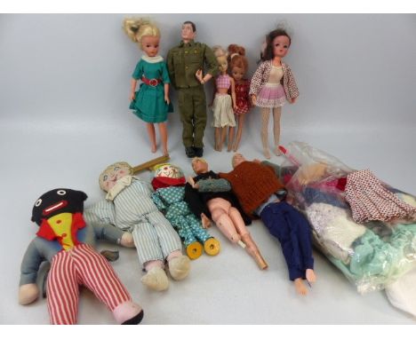 Barbie and Action man dolls along with a few others