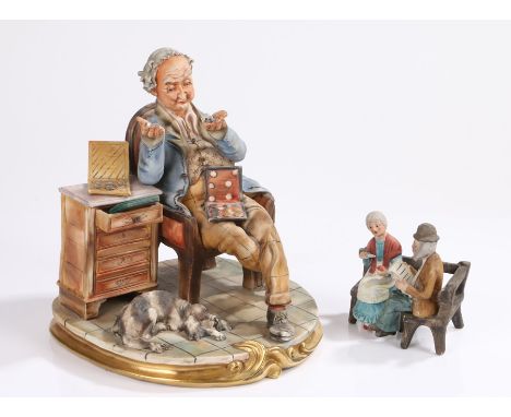 Capo-Di-Monte large porcelain figure depicting a man sitting on chair holding a collection of coins, together with an unmarke