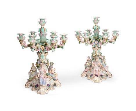 A PAIR OF CONTINENTAL PORCELAIN SEVEN LIGHT CANDELABRAEARLY 20TH CENTURYDecorated in tones of pink and turquoise and encruste