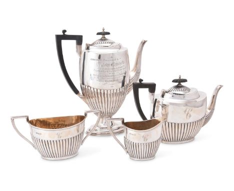 AN EDWARDIAN SILVER OVAL HALF REEDED FOUR PIECE TEA AND COFFEE SERVICE BY WALKER AND HALLSHEFFIELD 1904 AND 1905The tea and c